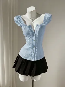 Detail view of a light blue puff sleeve shirt with waist-cinching design on a mannequin