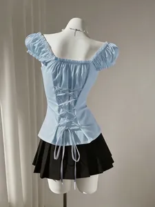 Close-up detail of a sweet light blue puff sleeve women's shirt with adjustable lace-up back
