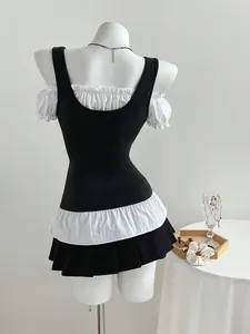 Back view of a slim-fit black and white tiered top with ruffled sleeves on a mannequin
