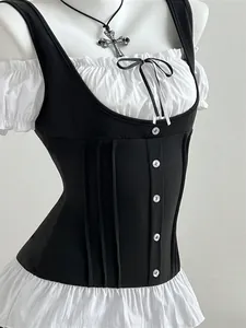 Close-up of black corset-style vest with white ruffled blouse and button details