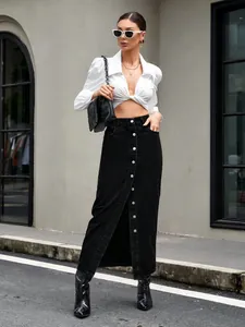 Full-body street style shot of a stylish retro black denim maxi skirt with front buttons