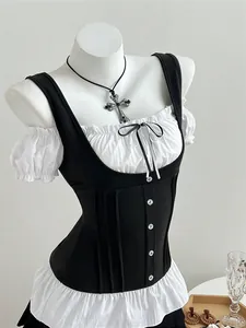 Close-up of gothic style black and white patchwork corset top with bow