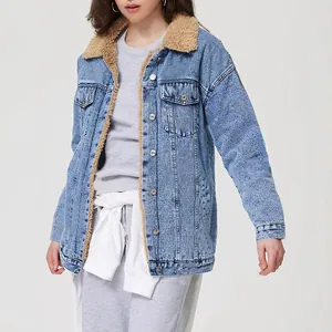 Detail shot of a women's loose-fit light wash denim jacket with warm sherpa lining