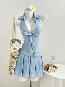 Light blue halter neck dress with V-neck bow and pleated skirt detail on white mannequin