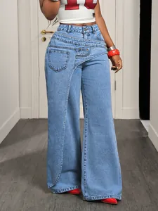 Detail view of stylish wide-leg denim jeans with unique asymmetrical waist design