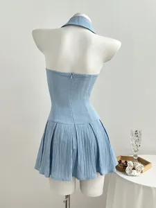 Back detail view of a light blue halter neck pleated mini dress on a white mannequin
