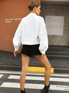 Stylish back view of white loose-fit cropped denim jacket with lantern sleeves for women