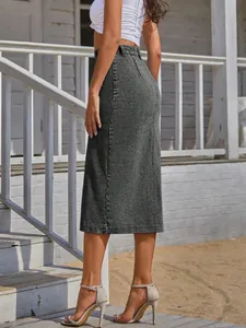 Detailed side view of a stylish grey high-waisted denim midi skirt for women outdoors.