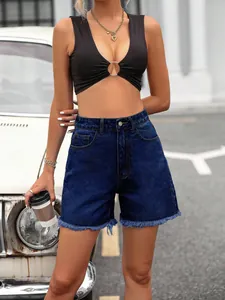 Stylish high-waisted dark blue denim shorts with trendy raw hem and frayed edges detail.