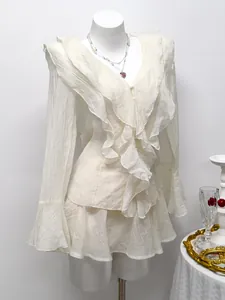 Elegant white ruffled chiffon blouse and skort set featuring pleated texture details