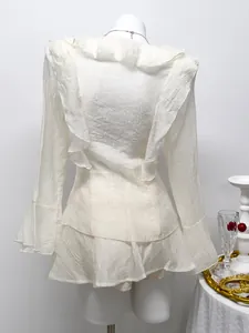 Back view of elegant white chiffon set with ruffles and flared sleeves detail