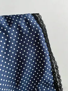Detailed view of blue polka dot fabric with high-quality black lace trim finish