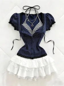 Close-up of blue polka dot short sleeve shirt with lace trim and ruffled white skirt