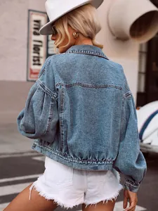Detailed rear view of a trendy light blue cropped denim jacket with loose sleeves