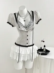 Detail showing the square neck and black lace trim of the slim fit polka dot blouse