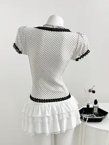 Detailed back view of a slim fit polka dot shirt with black lace trim and white skirt