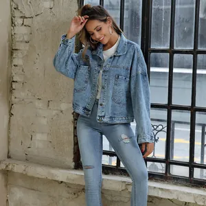Model wearing a retro loose light blue denim jacket with large pockets in outdoor setting