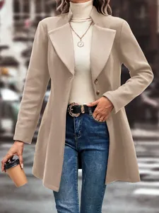 Detail view of an elegant tan wool coat with wide lapels and classic buttons on a model.