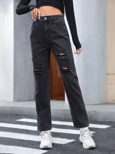 Full-length view of black distressed high-waisted straight leg jeans with ripped details