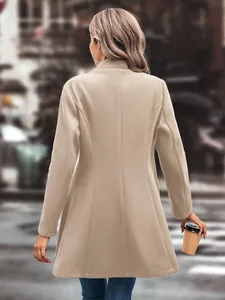 Elegant beige long-sleeved woolen coat with a slim fit cut seen from the back in a street setting.