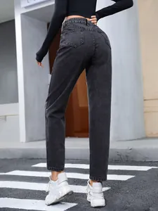 Back view of loose fit charcoal grey straight-leg denim jeans for women in urban street setting