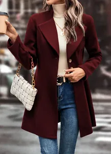 Close-up of a model wearing a stylish burgundy lapel wool coat with a white woven handbag