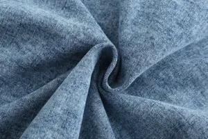 Macro detail of vintage blue denim fabric showing high-quality twill weave texture