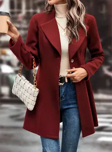 Detail view of a burgundy wool coat with lapel collar and a chic white woven handbag