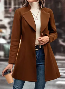 Detail view of a brown solid color lapel wool coat styled with a beige turtleneck sweater.