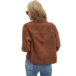 Vue arrière d'une femme à la mode portant une veste en velours côtelé marron et un jean