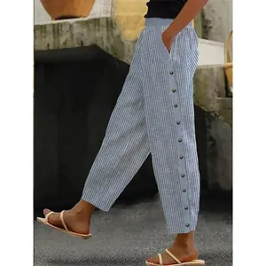 Detailed side view showing the button closure on women's blue striped casual trousers.