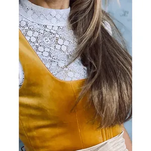 Close-up of Munich Oktoberfest dress with white lace blouse and yellow suede bodice