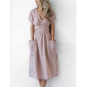 Close-up detail of a dusty pink cotton linen midi dress with V-neck and large front pockets