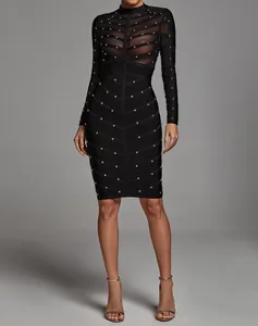 Elegant black long sleeve bandage dress with sheer mesh panels and gold stud details on model