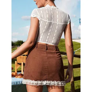 Elegant Oktoberfest outfit with lace top and brown skirt in outdoor picnic setting