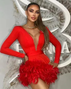 Close-up detail of red long sleeve bandage dress with deep V-neck and feather hem