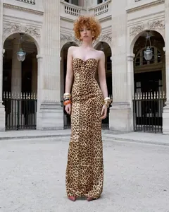 Elegant full body detail of a leopard print maxi dress worn by a model outdoors