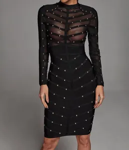 Elegant black bandage dress featuring sheer mesh panels and heavy gold stud embellishments