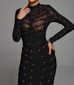 Detailed macro shot of heavy industry stud embellishments on black sheer mesh bandage dress