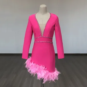 Detail of fuchsia bandage mini dress with deep V-neck, rhinestone trim and pink feathers