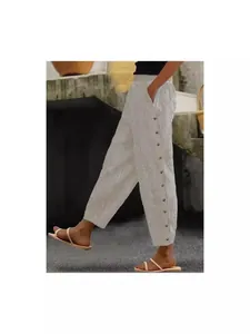 Chic women's vertical striped casual trousers featuring side button details and patchwork