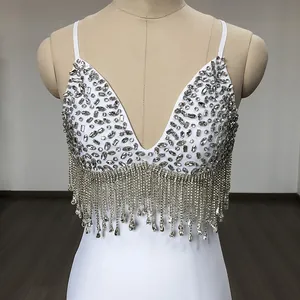 Detail of white bandage dress featuring intricate rhinestone and sequin embellishments