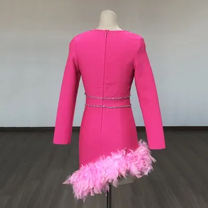 Back view detail of hot pink bandage dress with rhinestone waist and feather hem