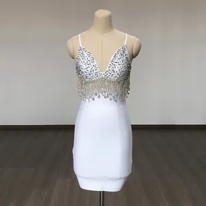 Detailed view of white bandage dress with sparkling sequins and dangling fringe tassels