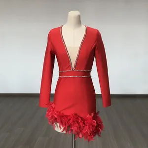 Red mini dress with deep V-neck, rhinestone detailing, and elegant feather hem trim.