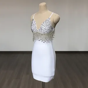 Detailed view of the sparkling rhinestone bodice and fringe tassels on a white dress