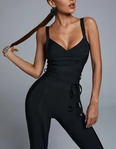 Detail view of a black bandage jumpsuit featuring a plunging V-neck and waist tie.