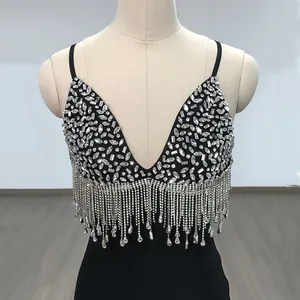 Close-up detail of black v-neck bodysuit with silver rhinestones and long tassel fringes