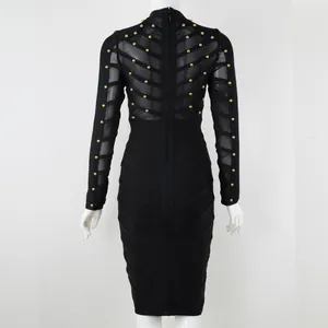 Detailed back view of a black bandage dress featuring mesh panels and gold stud embellishments