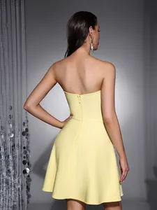 Back view of a yellow strapless cocktail dress with a zipper and waist-cinching design.